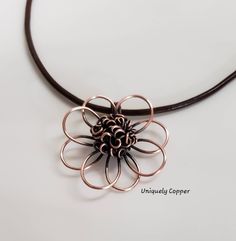 This gorgeous copper flower necklace is a perfect gift for your 7th Anniversary, Copper Anniversary, 22nd Anniversary, or as a gift for that special women in your life! The copper flower has been hand shaped, hammered, and wire wrapped to create the beautiful center of this copper pendant. It measures approximately 2 inches wide and 2 inches long. It has been antiqued and polished to a beautiful shine and is clear coated to protect the antique finish. It comes with your choice of either a black, 22nd Anniversary, Copper Anniversary Gifts, Copper Anniversary, Copper Gifts, Copper Cuff Bracelet, Leather Corded Necklace, 7th Anniversary, Copper Cuff, Flower Pendant Necklace