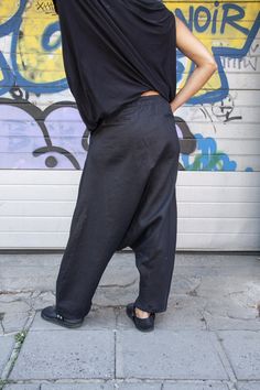 "Loose Linen Black Harem Pants, Extravagant Drop Crotch Black Trousers, Black Womens Linen Pants, Loose Harem Trousers, Navy Black Pants Update your streetwear with the Loose Linen Black Harem Pants. These Foll Loose Harem Pants feature a mid waisted construction, front zipeer and button closer, an elastic at the back of the waist. The trousers have two side pockets and two back pockets for convenient storage. Perfect for slaying in the streets, pair these linen pants with a loose shirt and spor Baggy Straight Sweatpants For Summer, Baggy Linen Ankle-length Pants, Baggy Tapered Leg Harem Pants For Summer, Casual Drop Crotch Pants For Spring, Spring Drop Crotch Relaxed Fit Pants, Baggy Ankle-length Sweatpants For Summer, Spring Drop Crotch Relaxed Pants, Spring Baggy Drop Crotch Harem Pants, Casual Harem Sweatpants For Summer