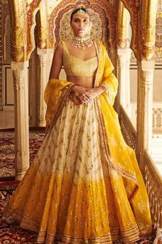 Yellow and off-white ombre lehenga featuring mukaish and gota patti embroidery. Paired with textured metallic blouse and organza brocade dupatta. Luxury Yellow Choli For Festivals, Luxury Yellow Lehenga For Puja, Luxury Orange Traditional Lehenga, Luxury Gold Jamawar Lehenga, Luxury Yellow Brocade Traditional Wear, Luxury Yellow Gown With Dupatta, Luxury Handloom Lehenga In Jamawar, Luxury Orange Floor-length Lehenga, Luxury Jamawar Lehenga For Women