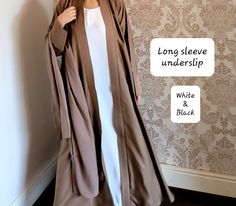 The perfect inner slip with long sleeves to style with any of our abayas. Each slip includes a belt too.  Material - soft touch Nidha (polyester)    Long sleeve - Black and half white. We also have a seperate listing for short sleeves.  https://www.etsy.com/listing/1352903192/abaya-slipunderslip-abaya-innerslip Please refer to the size guide in the images section.  No refunds/exchanges on this item. Elegant Long Sleeve Thobe For Eid, Elegant White Long Sleeve Abaya, Formal Long Solid Abaya, White Long Sleeve Thobe For Formal Occasions, Formal White Long Sleeve Thobe, Elegant Fitted Long Abaya, Elegant Long Fitted Abaya, Elegant Beige Long Thobe, Elegant Long Beige Thobe