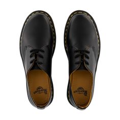 The 1461 from Dr. Martens is the British label's classic 3 eye derby. This iteration features a smooth black leather upper sitting atop the iconic AirWair sole. Yellow stitching and grooved edges along the rubber sole emphasize its distinctive Docs DNA. 3rd Eye, Eye Black, Dr. Martens, Derby, Rubber Sole, Leather Upper, Black Leather, Stitching, Yellow