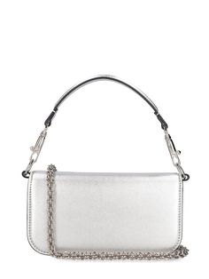 Find VALENTINO Locò Top Handle Bag on Editorialist. The VALENTINO GARAVANI Locò Top Handle Bag features a metal chain strap, a detachable leather top handle, and a front flap closure with a metal logo detail. The bag measures 11cm in height, 20cm in width, and 5cm in depth. The strap drop is 51cm and the handle drop is 11cm.