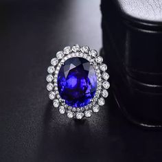 Welcome to Elegant Art Jewelry!  Material: 18k Solid White Gold Stone: Tanzanite Stone Weight: 14.86ct Stone Size: 13mm×17mm Stone Origin: Tanzania Stone Clarity: D Block Gemstone Cut: Oval Cut Side stone: Diamond Weight: 1.10ct Personalization: 9K/14K/24K/GOLD/SILVER/PLATINUM/ROSE-GOLD/WHITE GOLD. (Contact me)  Tanzanite Ring, Tanzanite Cuff Ring, 925 Sterling Silver Ring, Round Shape Ring, Tanzanite Ring, Tanzanite Engagement, Open Design Ring, Tanzanite Oval, Tanzanite Natural, Blue Tanzanite Elegant Tanzanite Diamond Cut Ring, Oval Moissanite Diamond Ring For Formal Occasions, Luxury Oval Tanzanite Diamond Ring, Formal Oval Emerald Ring With Halo, Luxury Oval Crystal Wedding Ring, Luxury Oval Diamond Cut Sapphire Ring, Dazzling Moissanite Sapphire Ring For Formal Occasions, Luxury Oval Halo Ring For Formal Occasions, Dazzling Oval Emerald Ring For Formal Occasions