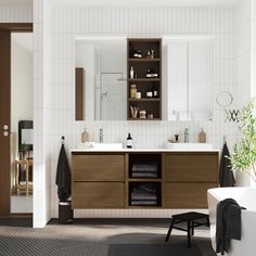 a bathroom with a sink, mirror and bathtub next to a plant on the floor