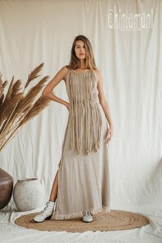 Bohemian Sleeveless Maxi Dress With Back Tassel Tie-up, Bohemian Floor-length Maxi Dress With Tassels, Bohemian Maxi Dress With Tassel Ties, Bohemian Natural Dresses For Festivals, Festival Maxi Dress With Tassel Ties, Beige Maxi Dress With Tassels, Summer Folk Dress With Tassels, Folk Style Summer Dresses With Tassels, Bohemian Maxi Dress For Gatherings