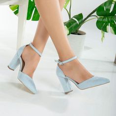 a woman's legs wearing blue high heels with ankle straps and heeled shoes