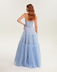 Dreamy tulle dress in light blue color with a light ruffled tulle maxi skirt. This dress has a heart-shaped boned semi-transparent bodice with built-in cups and a corset back, which makes the silhouette fitted and elegant. The A-line maxi skirt is made from multiple layers of delicate tulle that emphasize the hourglass silhouette. The waistline is adorned with a silver belt with Milla’s signature.This dress comes with straps, adding an elegant touch. Details: Material: Tulle Fabric composition: Asymmetrical Dress Casual, Night Concert, One Shoulder Dress Long, Outfits Formal, Winter Wedding Guest, Winter Wedding Guest Dress, Tulle Maxi Dress, Tulle Maxi Skirt, Hourglass Silhouette