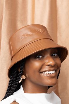 A caramel-brown bucket hat embossed with “Melanin-Rich”. Brown Bucket Hat With Curved Brim, Trendy Brown Bucket Hat With Curved Brim, Trendy Brown Bucket Hat With Flat Brim, Trendy Brown Flat Brim Bucket Hat, Brown Bucket Hat, Leather Bucket Hat, Carmel Brown, Upcycled Fashion, Caramel Brown