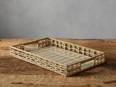 a wicker tray sitting on top of a wooden table