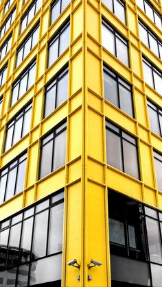 a tall yellow building with lots of windows