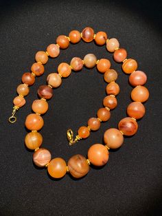 Ancient Indo-Tibetan agate beads necklace very beautiful color and very smooth skin of this agates we provide fast and free shipping to our customers by which can get the items by 7 maximum working days Round Carnelian Orange Beads, Round Orange Carnelian Beads, Vintage Orange Beads, Gems, And Cabochons For Gifts, Amber Natural Stones Round Beads, Orange Carnelian Beads, Orange Agate Round Beads Necklace, Round Carnelian Beads For Jewelry Making, Orange Agate Round Bead Necklaces, Orange Agate Beads