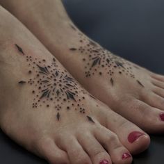 a woman's feet with tattoos on them