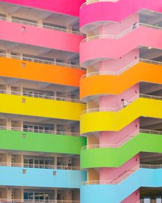 a multicolored building with balconies and balcony railings