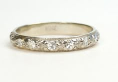 an antique style wedding band with five diamonds