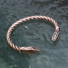 Please note that we only ship via FedEx (outside of the EU) and DPD (within the EU). The price is dependent on those carrier services' price lists. Snake - a bronze bracelet. Designed by Kati. Please note that FedEx does NOT deliver to PO boxes! Antique Bronze Metal Bracelets, Bronze Electroformed Metal Bracelet, Adjustable Antique Bronze Bangle, Handmade Viking Style Bronze Jewelry, Viking Style Metal Bracelet Jewelry, Bronze Brass Jewelry For Larp, Adjustable Bronze Copper Bangle, Medieval Bronze Jewelry With Antique Finish, Medieval Style Bronze Jewelry With Antique Finish