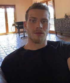 a man with a beard sitting in a living room