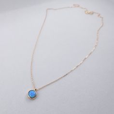 "\"Blue Opal Necklace | Opal Gemstone Pendant | Minimal and Elegant Gold Necklace for Daily Use | Anniversary Valentine Gift | Gift for Her\" In the Middle Ages, opal was considered a stone that could provide great luck because it was believed to possess all the virtues of each gemstone whose color was represented in the color spectrum of the opal. It was also said to grant invisibility if wrapped in a fresh bay leaf and held in the hand. This minimal necklace is a perfect minimal gift for your Blue Birthstone Dainty Jewelry, Blue Dainty Birthstone Jewelry, Dainty Blue Birthstone Jewelry, Minimalist Opal Pendant Jewelry, Blue Clavicle Chain Necklace As A Gift For Her, Blue Pendant Jewelry With Delicate Chain, Blue Fine Jewelry With Bezel Setting, Elegant Opal Clavicle Chain Jewelry, Blue Birthstone Necklace As Gift For Her