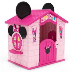 a pink castle with minnie mouse ears on it's roof and door is shown in front of a white background