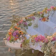 a boat with flowers on it floating in the water