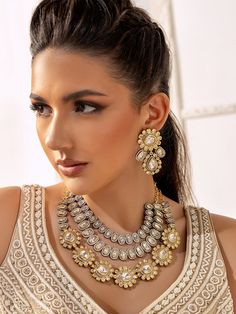 a woman wearing a necklace and earrings