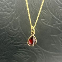 A red Garnet drop pendant with a brass necklace sounds like a beautiful piece of jewelry. Garnet is a deep red gemstone known for its rich color and symbolism of love and passion. The brass necklace adds a touch of elegance and complements the red Garnet pendant nicely. It would make a great addition to any jewelry collection or a thoughtful gift for someone special. Yellow Gold Teardrop Ruby Necklace, Yellow Gold Ruby Teardrop Necklace, Teardrop Ruby Necklace In Yellow Gold, Red Briolette Necklaces For Jewelry Making, Red Ruby Gemstone Necklaces, Red Briolette Beads For Jewelry Making, Red Garnet Round Pendant Necklace, Red Ruby Gemstone Necklace, Red Garnet Pendant Necklace