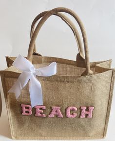 Thank you for visiting Designs By Kenia! Every time you shop small, you are supporting someone's dream and I am SO thankful that you have chosen to support mine! Beach Tote Bag|Girls Trip Tote Bag|Persoanlized Beach Bag|Summer Beach Bag|Gifts For Her|Beach Trip|Beach Tote This bag Is the perfect beach bag bag to carry all the beach essentials. Our bags are personalized with letter paches. The letters are beautiful and you get to choose what color letters you want. All letters will have the gold Beachy Shoulder Bag In Sand Color For Beach, Beachy Sand-colored Shoulder Bag For Beach, Summer Vacation Bags In Sand Color, Summer Vacation Bag In Sand Color, Beachy Sand-colored Shoulder Bag For Vacation, Beachy Rectangular Bags For Beach Season, Sand Color Tote Bags For Beach Season, Cute White Beach Bags, Summer Vacation Sand-colored Bags