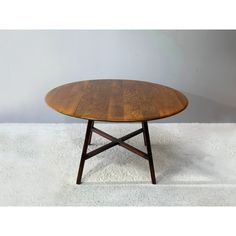 a wooden table sitting on top of a white floor