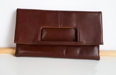 Simply elegant vintage 2 in 1 made in Montreal Canada signed ''Chic'' reddish-brown leather women purse convertible clutch or handbag with one external pocket which closes with a zipper. The interior linen is in brown faux suede. 10 x 10 x 0.5 inches when worn as a handbag and 10 x 5-3/4 x 7/8 inches when worn as a clutch. As shown in the picture, this purse can be worn as clutch or as handbag Good condition with very clean interior and minor surface scratches due to storage and minor discoloration of the brown color on the corners on the bottom -  sold as is -return not accepted. Very solid built - this purse was worn a couple of times only. To make this a smooth and pleasant transaction experience for everyone, all buyers need to read and understand the description, the terms of sale , t Brown Leather Evening Clutch, Retro Brown Wallet For Everyday Use, Elegant Brown Clutch With Fold Over Clasp, Chic Brown Handheld Clutch, Brown Soft Leather Pouch Clutch, Brown Soft Leather Shoulder Clutch, Chic Brown Office Clutch, Brown Envelope Shoulder Bag With Removable Pouch, Vintage Leather Travel Clutch