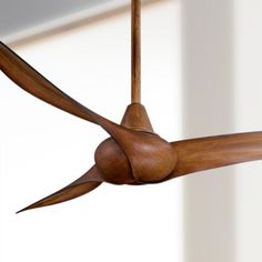 a ceiling fan with wooden blades hanging from it