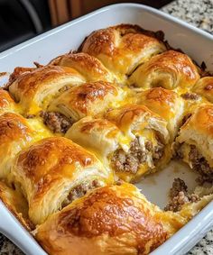 a casserole filled with meat and cheese in a white dish on a counter