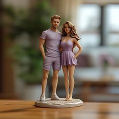 a man and woman figurine standing next to each other on a wooden table