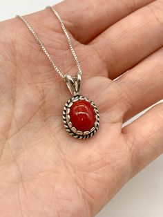 Red Coral Necklace set with a Natural Red Coral in a top grade & strong red color, at 10x8mm, 3 Cts, from Sardinia. Solid 925 Sterling Silver ☞ made to last.Matching Ring & Matching Earrings: Please ask meDetails: • Natural Red Coral sourced from Sardinia• Red Coral: 10x8mm, 3 Cts, diamond cut• Dimensions: Pendant Height 19.6mm, Width 9.2mm• Free Complimentary Chain• Solid 925 Sterling Silver ❀ Each Natural Gem is unique & will have Slight variations from the product pictures "no two Natural Sto Classic Red Jewelry As A Gift, Classic Red Hallmarked Necklace, Classic Red Necklaces For Anniversary, Elegant Red Cabochon Jewelry, Red Oval Fine Jewelry, Fine Red Oval Jewelry, Classic Red Round Jewelry, Red Carnelian Oval Necklace, Red Oval Carnelian Necklace