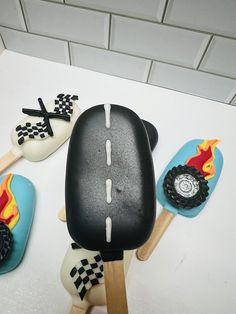 a cake made to look like a car with flames and wheels on the side, sitting on top of a table