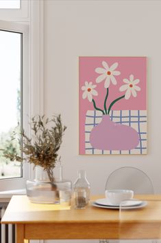 a vase with daisies in it sitting on a table next to a plate and cup