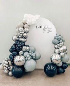 two black and white balloons are in front of a sign that says bride to be