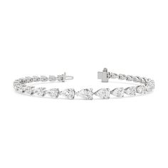 An icon of beauty. This tennis bracelet showcases well-proportioned pear diamonds arranged in graduating sizes, in an exquisite trailing design. The incredibly flattering pear diamonds are laid out in an east-west setting, highlighting the slender and graceful silhouette of each gem. Luxury Pear-shaped Diamond Bracelet For Wedding, Pear-shaped Brilliant Cut Diamond Bracelet For Formal Occasions, Luxury White Gold Pear-shaped Diamond Bracelet, Formal Pear-shaped Diamond Bracelets, Luxury Pear-shaped White Gold Diamond Bracelet, Pear-shaped Luxury Bracelets For Formal Occasions, Luxury Pear-shaped Bracelets For Formal Occasions, Luxury Pear-shaped Formal Bracelets, Formal Pear-shaped Brilliant Cut Diamond Bracelet