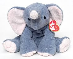 an elephant stuffed animal with a tag on it's ear, sitting in front of a white background