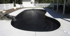 a backyard with a pool and white fence