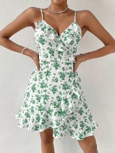 This beautiful WYWH Floral Print Ruffle Trim Wrap Knot Side Cami Dress is the perfect addition to your summer wardrobe. Its lightweight and flowy fit is crafted from 95% Polyester and 5% Elastane fabric, with fresh all-over floral print accents and ruffle and wrap detail that add a touch of boho-chic to your look. The sleeveless spaghetti strap dress features a high waist and regular fit, perfect for twirling in the sunshine. Style: Boho Pattern Type: Floral, All Over Print Details: Ruffle, Wrap Flowy Chiffon Ruffle Dress For Summer, Summer Flowy Chiffon Ruffle Dress, Flirty Ruffle Hem Dress For Beach, Flirty Ruffle Hem Dress For The Beach, Flirty Ruffle Dress With Ruffle Hem For The Beach, Summer Chiffon Ruffle Dress, Flowy Fit, Feminine Summer Mini Dress With Ruffles, Feminine Ruffled Mini Dress For Summer, Green Ruffled Mini Dress For Summer