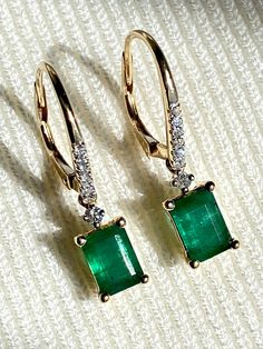 Genuine Colombian emerald and diamonds  VS1 earrings carats 14k gold Earrings Details Metal: 14k Yellow Gold Weight: 2.6 grams  Emeralds carat weight 3  Side stones: 14 round diamonds VS1 * It's a very flattering minimalist earring perfect for any occasion. Packing Each order will be beautifully packaged for gift giving in a jewelry box. We only sell genuine natural emeralds directly from the Colombian mines of Chivor, Muzo, and Coscuez. The emerald mines of Chivor, Muzo, and Coscuez provide the best quality emeralds in the world because of their characteristics of color and clarity. The rarest and most expensive emeralds in the world have been discovered in these mines. Carved Emerald Earrings, Multi-stone Emerald Earrings For Gift, Luxury Pear-shaped Emerald Earrings, Colombian Emerald Earrings, Columbian Emeralds, Minimalist Earring, Colombian Emeralds, Natural Emerald, Gold Details