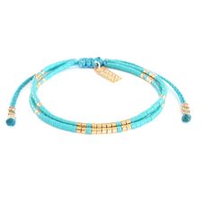 the turquoise and gold beaded bracelet is shown with two beads on each side,