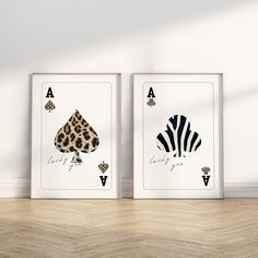 two framed art prints on the wall, one with a leopard print and one with a zebra print