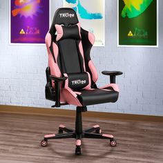 a pink and black office chair sitting on top of a hard wood floor next to a white brick wall