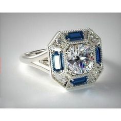 a diamond and sapphire ring with blue accents