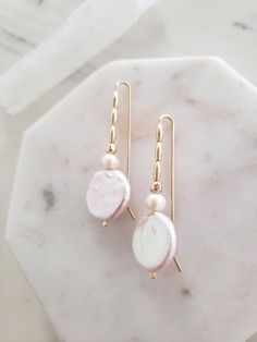 These earrings are unique yet perfectly on trend and timeless. Perfect for dressing up a casual look or for a bride on your wedding day! Handmade from top quality materials. Genuine lustrous freshwater coin pearls are threaded with 14k gold filled beads on 14k gold filled wire. Gold fill does not wear off like gold plated. Water safe! Hypoallergenic, lead and nickel free. Comfortable and lightweight! Come packaged in a gift box. **What is 14k Gold-fill?** Gold fill does not tarnish or wear off a 14k Gold Filled Pearl Drop Earrings For Anniversary, Minimalist Pearl White Bridal Earrings With Pearl Drop, Minimalist Pearl White Pearl Drop Bridal Earrings, Feminine Pearl White Drop Bridal Earrings, Pearl White Earrings With Pearl Charm In 14k Gold, 14k Gold-filled Pearl White Earrings With Pearl Charm, Minimalist Pearl Pendant Earrings For Wedding, Minimalist Pearl White Pearl Earrings For Wedding, Minimalist Pearl Drop Wedding Earrings