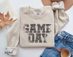 Game Day Shirt, Touchdown Football Shirt, Game Day Mom Shirt, Game Day Sweatshirt, Football Sweatshirt, Sport Mom Shirt HOW TO ORDER: Check all photos. Select your size. Select your color. Enter design or text color in the personalization box (see images for options). Select the quantity. Add to cart. Complete checkout. SWEATSHIRT DETAILS: 50% Cotton, 50% Polyester 1x1 ribbed collar, cuffs, and waistband with spandex Set-in sleeves UNISEX SIZING Brands: Gildan, Jerzees, Hanes, Laviva (brand not Game Day Sweatshirt, Sports Mom Shirts, Sport Mom, Sweatshirt Details, Football Sweatshirt, Game Day Shirts, Sports Mom, Football Shirt, Mom Shirt