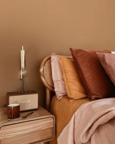 a bedroom with a bed, night stand and lamp on the bedside table next to it