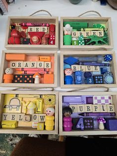 four wooden boxes filled with different types of toys