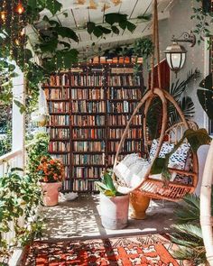 a room filled with lots of books and plants