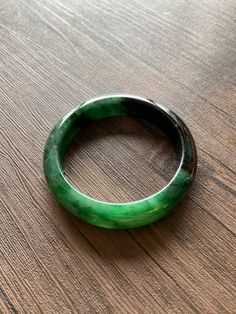 "🌈 Jade Bangle 59.7mm (2.35\"), Round Shape, Green & Light Green 🌷 Untreated Natural Jadeite/ Grade A Jade 🌷 Certification : Yes 🌷 Jade from Myanmar/ Burma 🌷 Shape : Round 🌷 Inner diameter : 59.7mm / 2.35\" 🌷 Width & Thickness : 14.2 x 8.8mm 🌷 Color : Green & Light Green 🌷 Free standard shipping from Hong Kong with tracking included 🌷 Take approximately 7-21 days to arrive worldwide ❤️ In Chinese Culture: Young people wear jade pendant will have a prosperous life, attracts Handmade Round Jade Bangle, Vintage Jade Round Bracelets, Vintage Round Jade Bracelets, Vintage Jade Bracelets, Carved Jade Bangle Bracelet, Adjustable Carved Round Bracelets, Adjustable Carved Bracelets, Green Carved Bangle Bracelet, Green Carved Bangle Bracelets